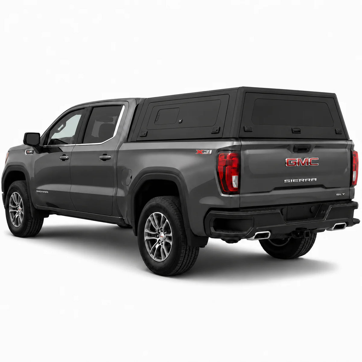 A dark gray GMC Sierra pickup truck with a black hardtop canopy over the bed, shown from a rear three-quarter angle on a light gray studio background.