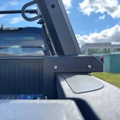 Close-up of steel truck bed rack attachment to bed rail