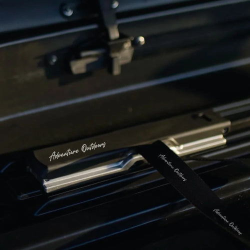 Stream AO roof cargo box interior detail showing integrated tie-down strap for securing rooftop cargo
