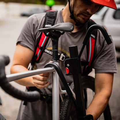 Close-up of a person securing a bike to the Swagman XTC ratchet arm.