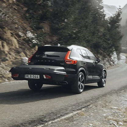 Thule Arcos Platform with cargo box on SUV driving on mountain road