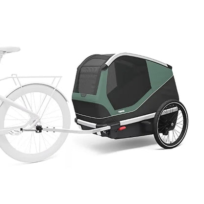 Thule Bexey Large dog bike trailer hitched to bicycle, showcasing spacious design and stable two-wheel construction for safe rides