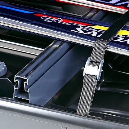 Thule ski carrier adapter close-up view inside roof box with ski strap secured