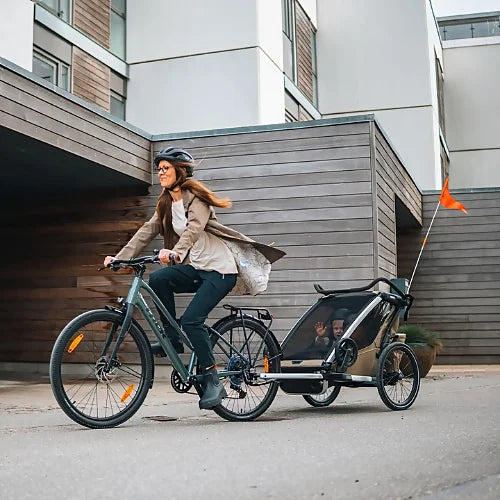 Thule Chariot Cross 2 Double Faded Khaki bike trailer in motion during family ride with children safely seated inside