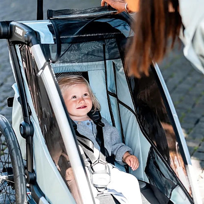 Thule Chariot Cross Single interior with padded seat and 5-point harness showing child comfort and safety