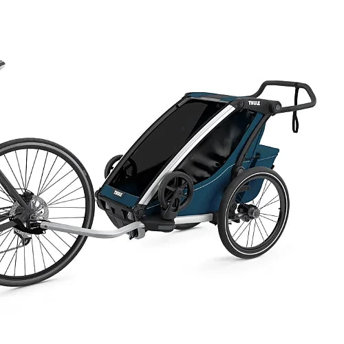 Thule Chariot Cross Single Majolica Blue connected to bicycle as a child trailer for family outdoor adventures