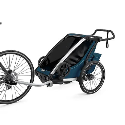 Thule Chariot Cross Single Majolica Blue connected to bicycle as a child trailer for family outdoor adventures