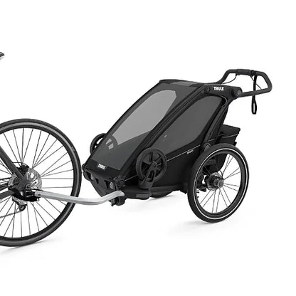 Thule Chariot Sport Single bike trailer connected to bicycle with tow arm and safety strap