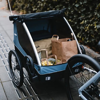 Thule Courier cargo mode carrying groceries and bags on bike path