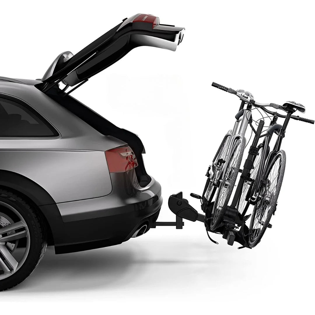 Thule DoubleTrack Pro installed on car with open trunk, holding 2 bikes