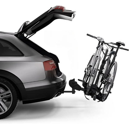 Thule DoubleTrack Pro installed on car with open trunk, holding 2 bikes