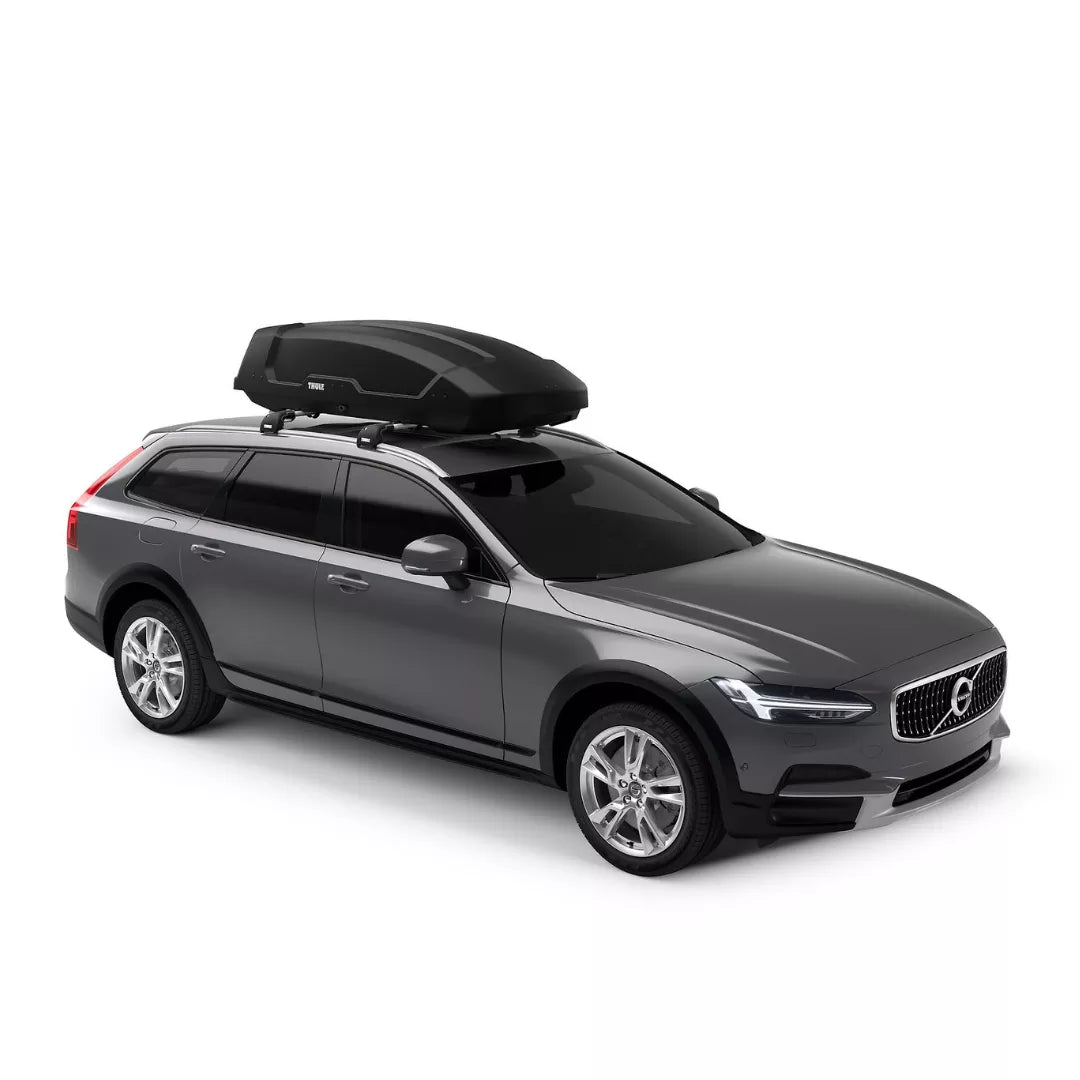 Full side view of a dark grey station wagon with a Thule Force XT mounted on the roof.