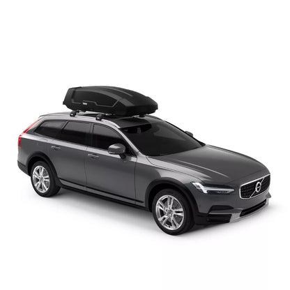 Full side view of a dark grey station wagon with a Thule Force XT mounted on the roof.