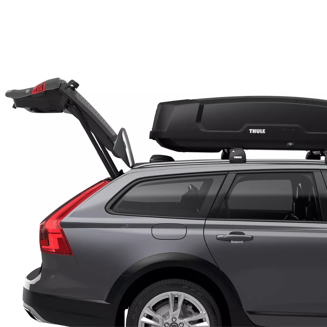 side view of a car with its trunk open, showcasing clearance with the Thule Force XT roof box.