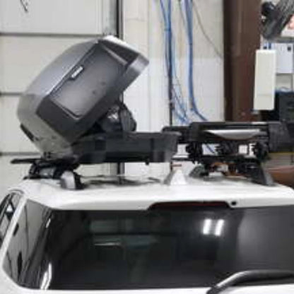 Thule force xt sport roof box mounted on a vehicle with a warehouse background