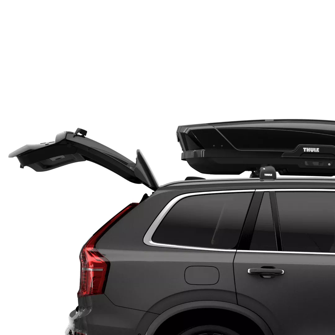 Thule Motion XT installed on an SUV with the trunk open to show hatch clearance compatibility.

