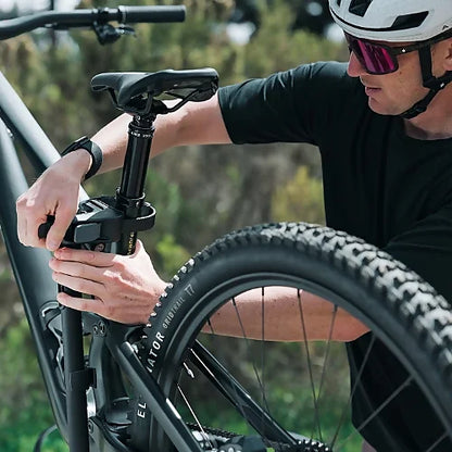 Close-up of cyclist adjusting frame clamp on Thule OutPace Hitch Bike Rack