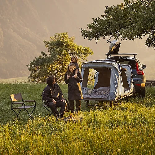 Thule Outset Hitch Car Tent set up behind SUV with family enjoying outdoor elevated camping experience