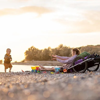 Thule Reacha Sport bike trailer on beach used for outdoor family adventure, showing versatility and lightweight frame