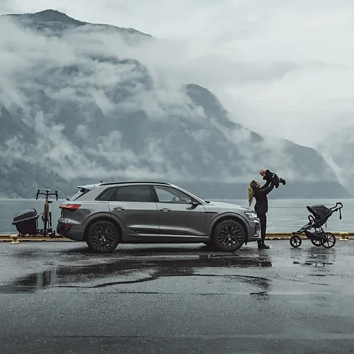 Thule Santu Hitch Cargo Box on car beside mountain lake with family outdoors