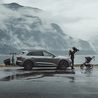 Thule Santu Hitch Cargo Box on car beside mountain lake with family outdoors