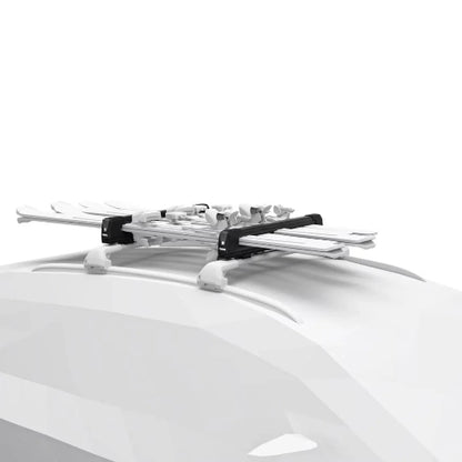 Thule SnowPack Extender mounted on car roof carrying multiple pairs of skis