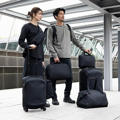 Travelers using Thule Subterra 2 carry-on spinners and bags in real-world travel setting