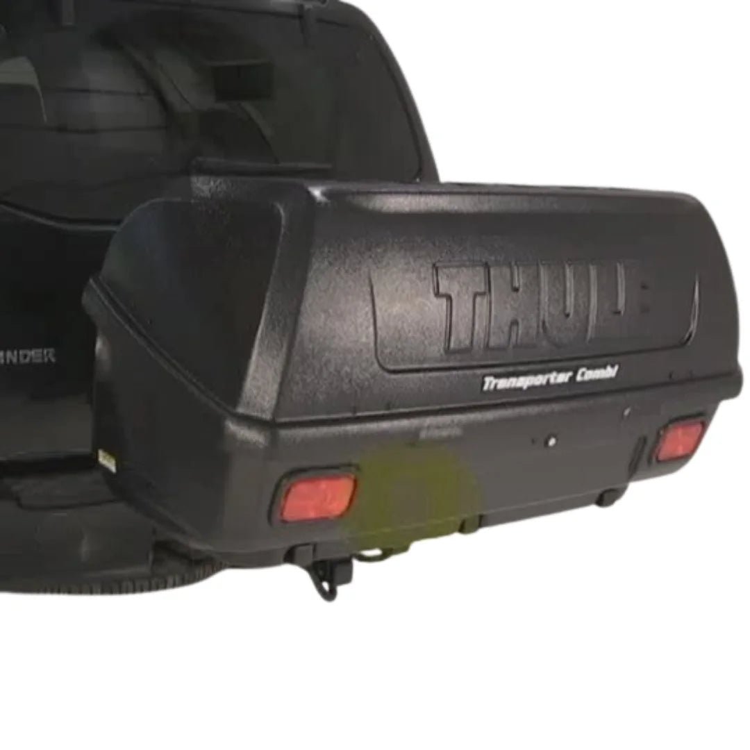 Black Thule transporter hitch cargo box attached to a vehicle's hitch