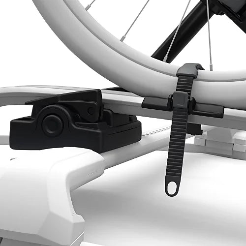 Close-up of Thule UpRide rear ratcheting wheel strap securing rear bike wheel
