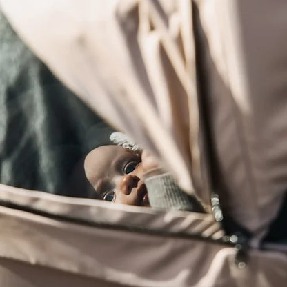 Baby peeking through Thule Urban Glide 3 peek-a-boo canopy window during stroll