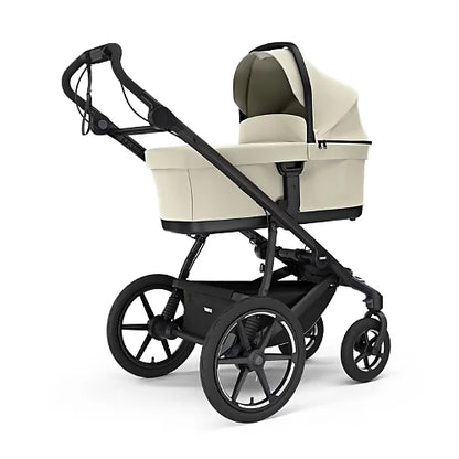 Thule Urban Glide 4-Wheel stroller with beige newborn bassinet attached for use from birth