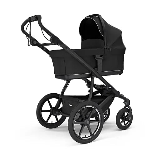 Thule Urban Glide 4-Wheel stroller with newborn bassinet in black showing travel system capability