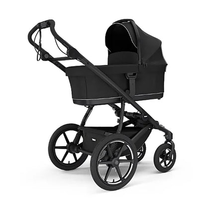 Thule Urban Glide 4-Wheel stroller with newborn bassinet in black showing travel system capability
