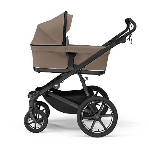 Thule Urban Glide 4-wheel stroller with tinted taupe bassinet attached for newborn use