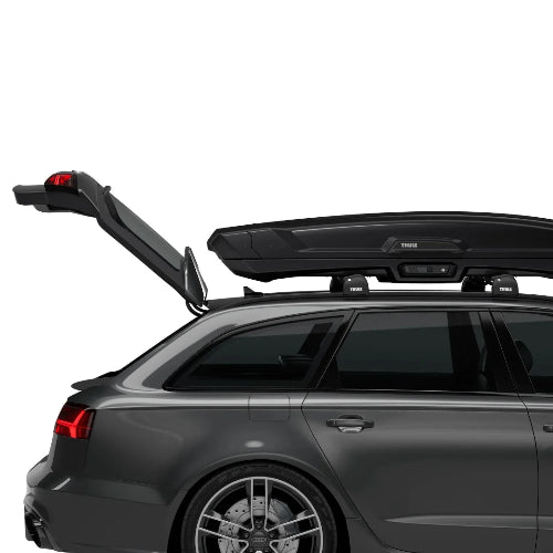 Thule Vector Alpine mounted on vehicle roof showing full trunk access and low-profile aerodynamic fit