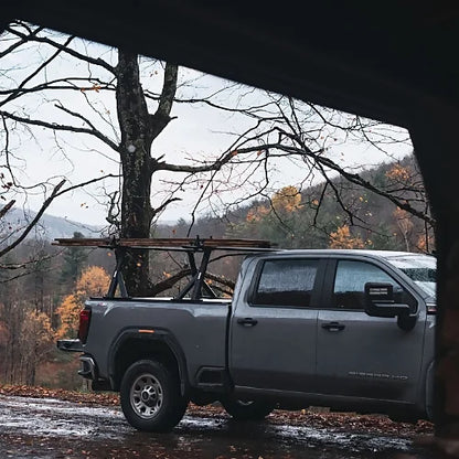 Thule Xscape SR baserail truck rack mounted on pickup truck carrying cargo in outdoor mountain environment