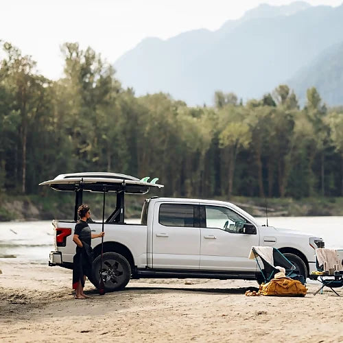Thule Xscape rack carrying surfboards on a pickup truck during an outdoor beach adventure
