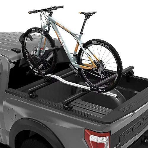 Thule Xsporter Pro Low truck rack carrying bike on mounted crossbars for adventure trips