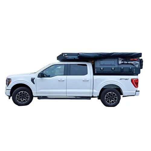 Side profile of pickup truck with camper roof closed for driving mode