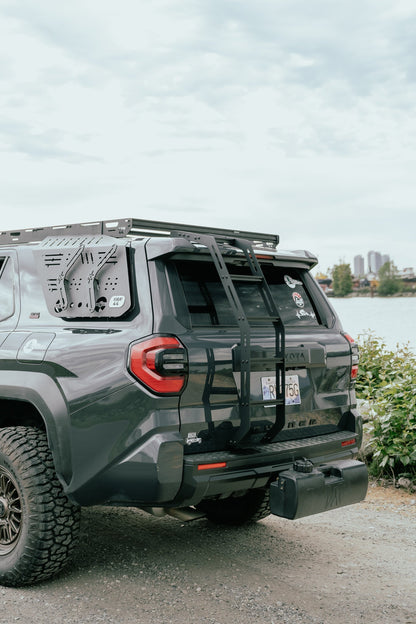 Gray SUV with roof rack parked by a lake