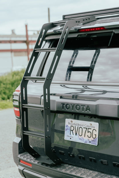 Back of a Toyota 4runner with a Van44 hatch ladder and British Columbia license plate.