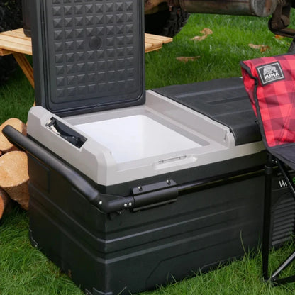 Open Wabban fridge placed on grass near a picnic setup