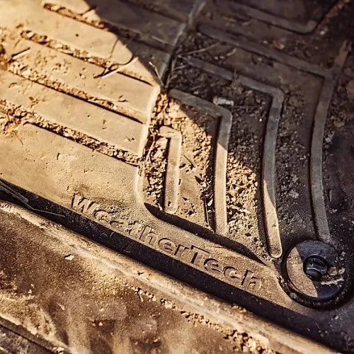 WeatherTech logo close-up on floor mat with trapped dirt and grime