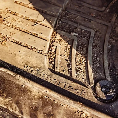 WeatherTech logo close-up on floor mat with trapped dirt and grime