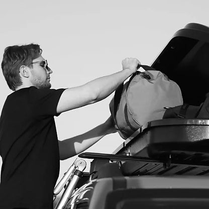 Woods Star roof cargo box being loaded with gear on a vehicle roof rack