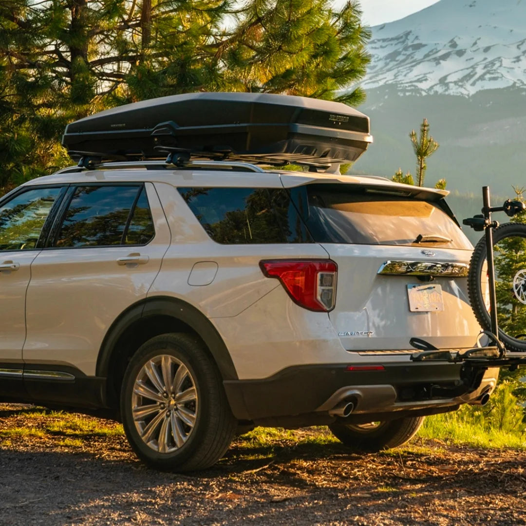 Yakima CBX mounted on Ford Explorer SUV in mountain setting