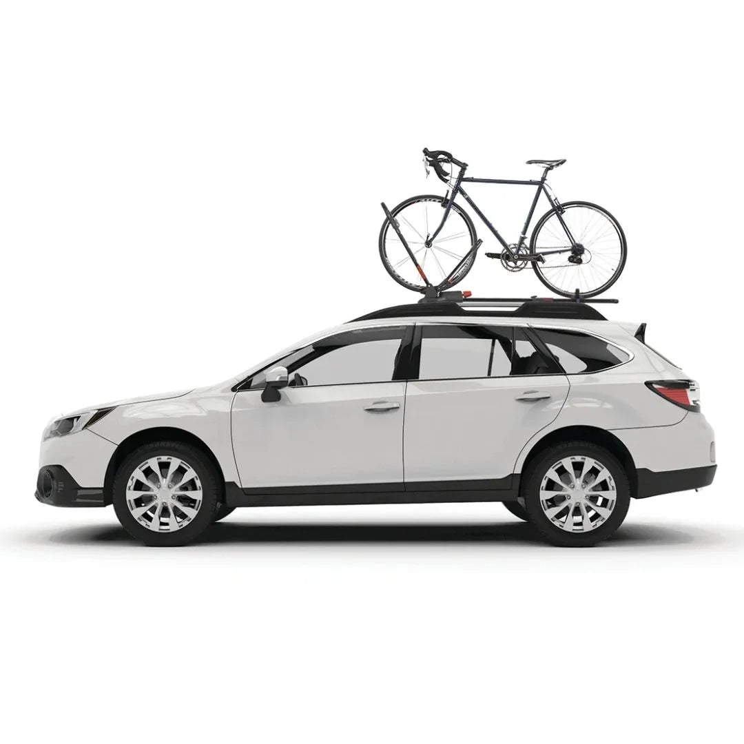 White wagon driving with a road bike mounted on the roof using the Yakima FrontLoader bike rack.