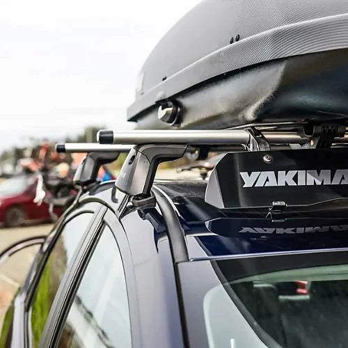 Yakima JetStream roof rack crossbars installed on a vehicle supporting a rooftop cargo box for travel and adventure use