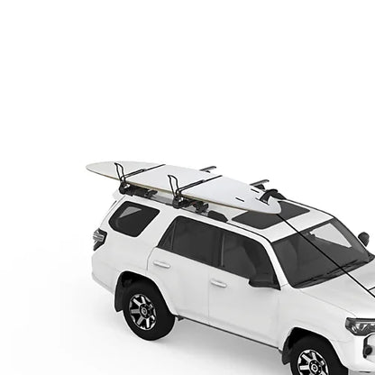 Yakima ShowDown carrying surfboards and paddleboards secured on SUV roof rack.