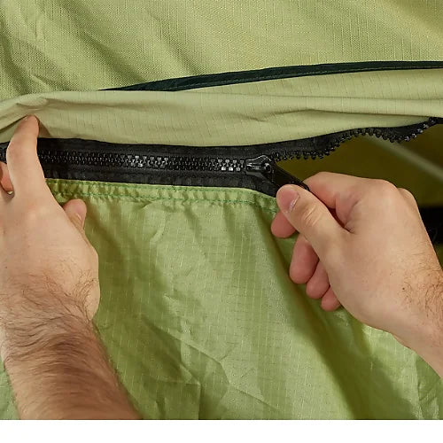 Hands zipping Yakima SkyRise HD Annex to rooftop tent during setup